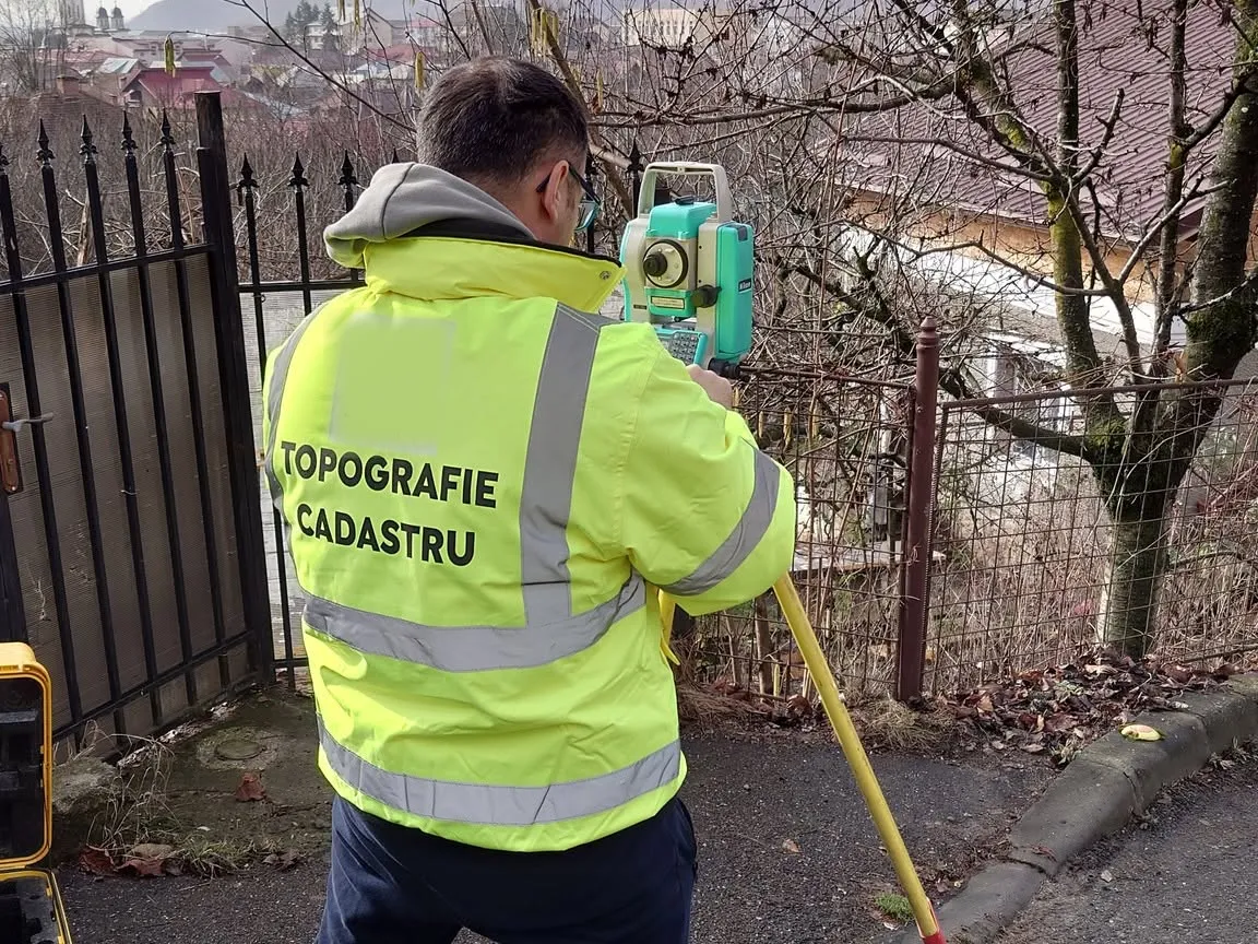 Inginer topograf măsurând cu stația totală Nikon pe o stradă din Dâmbovița
